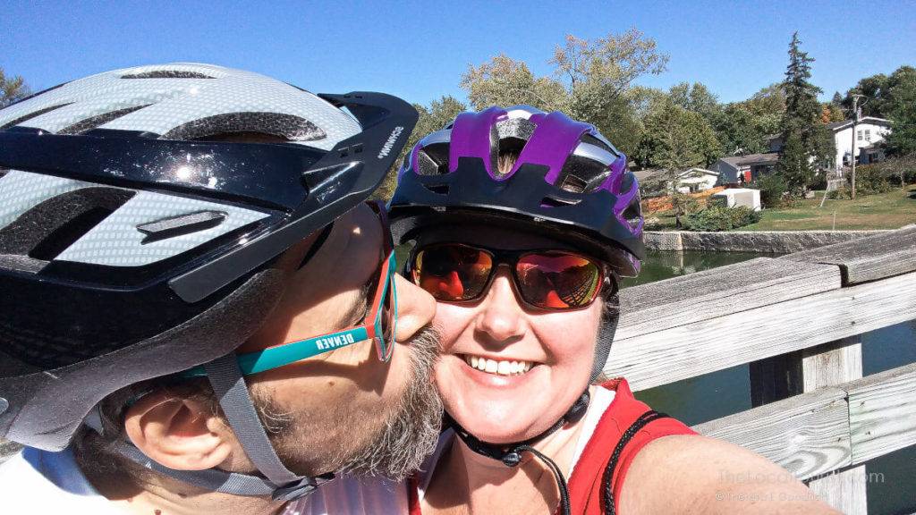Jim kissing Theresa because they're so happy after a bike ride