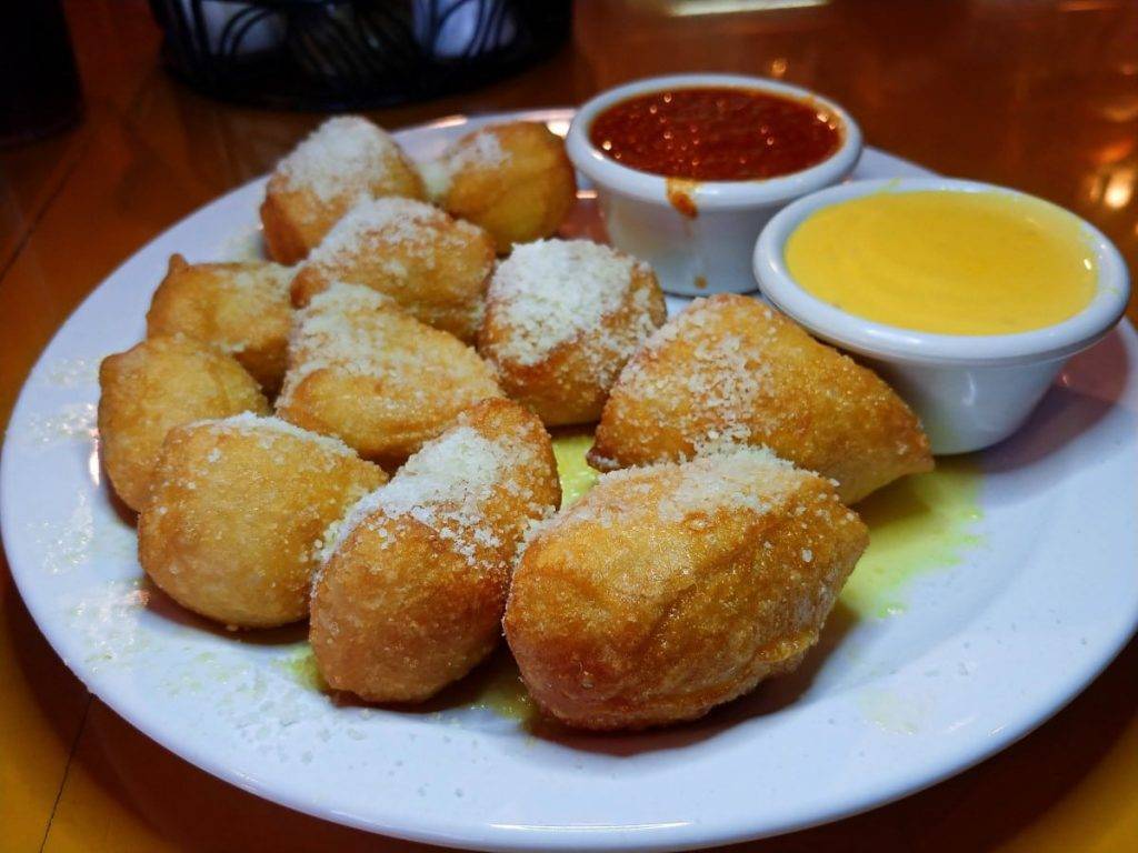 Bruno Dough, deep fried pizza dough topped with butter and parmesan and served with marinara and cheese sauce.